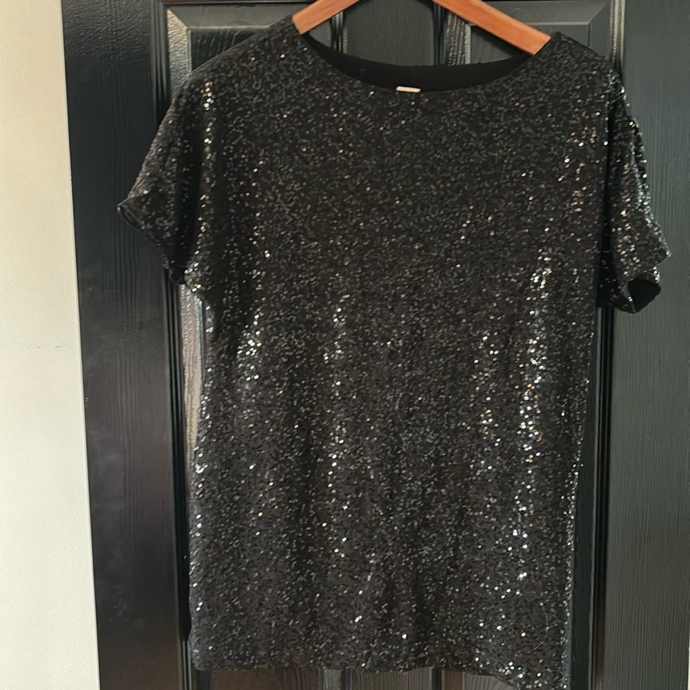 Black sequinned short sleeved shirt.